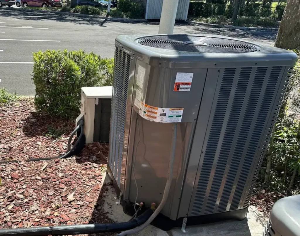 Residential AC condenser installation featuring a liquid line filter drier to protect the system from moisture and contaminants.