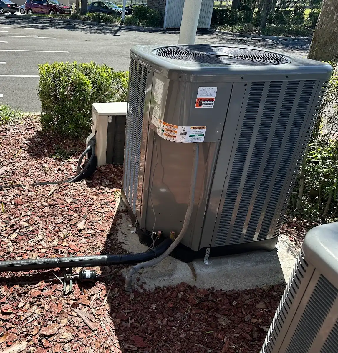 Residential AC condenser installation featuring a liquid line filter drier to protect the system from moisture and contaminants.