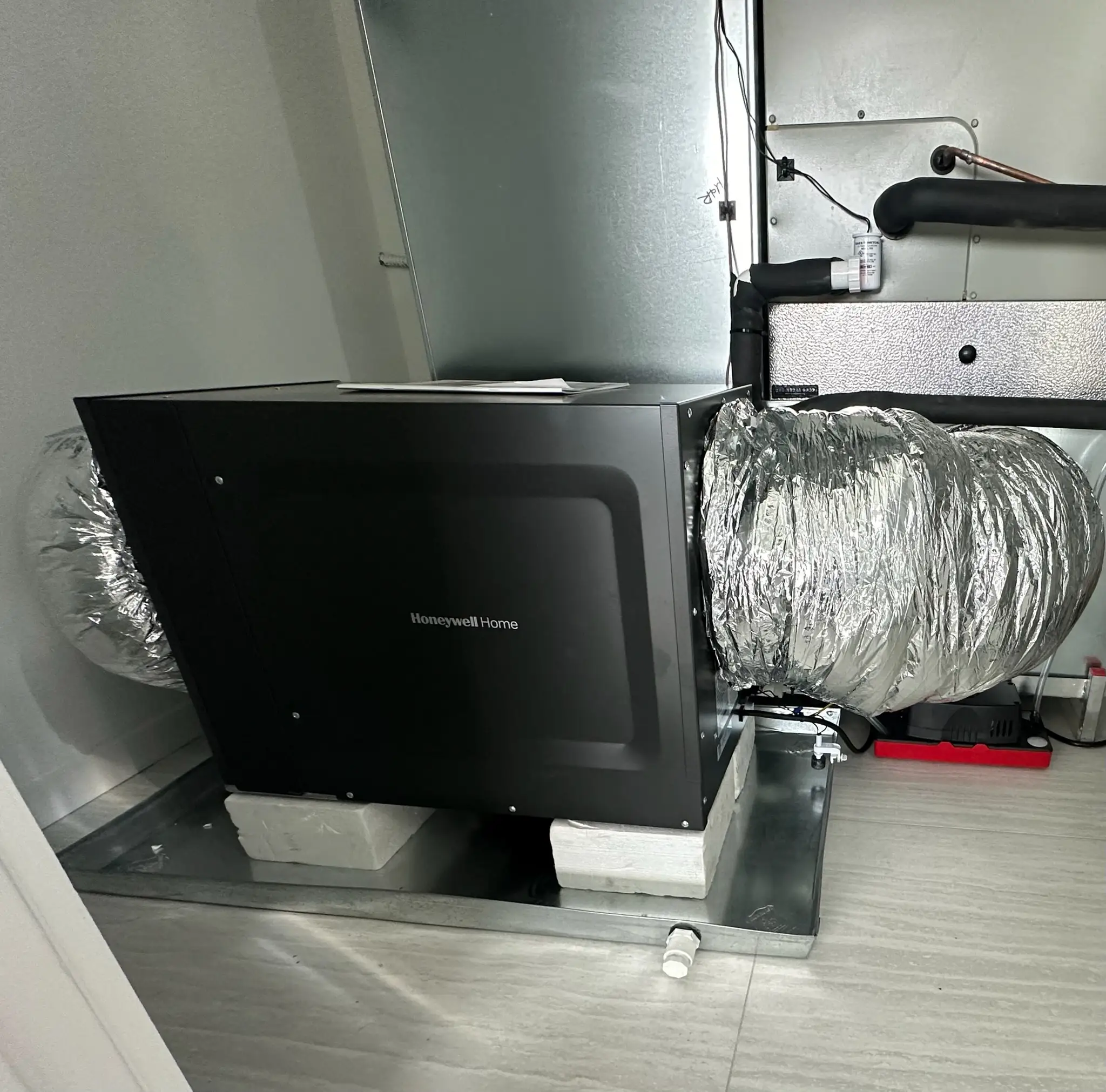 HVAC air handler installation connected to ductwork system for improved indoor airflow and energy efficiency