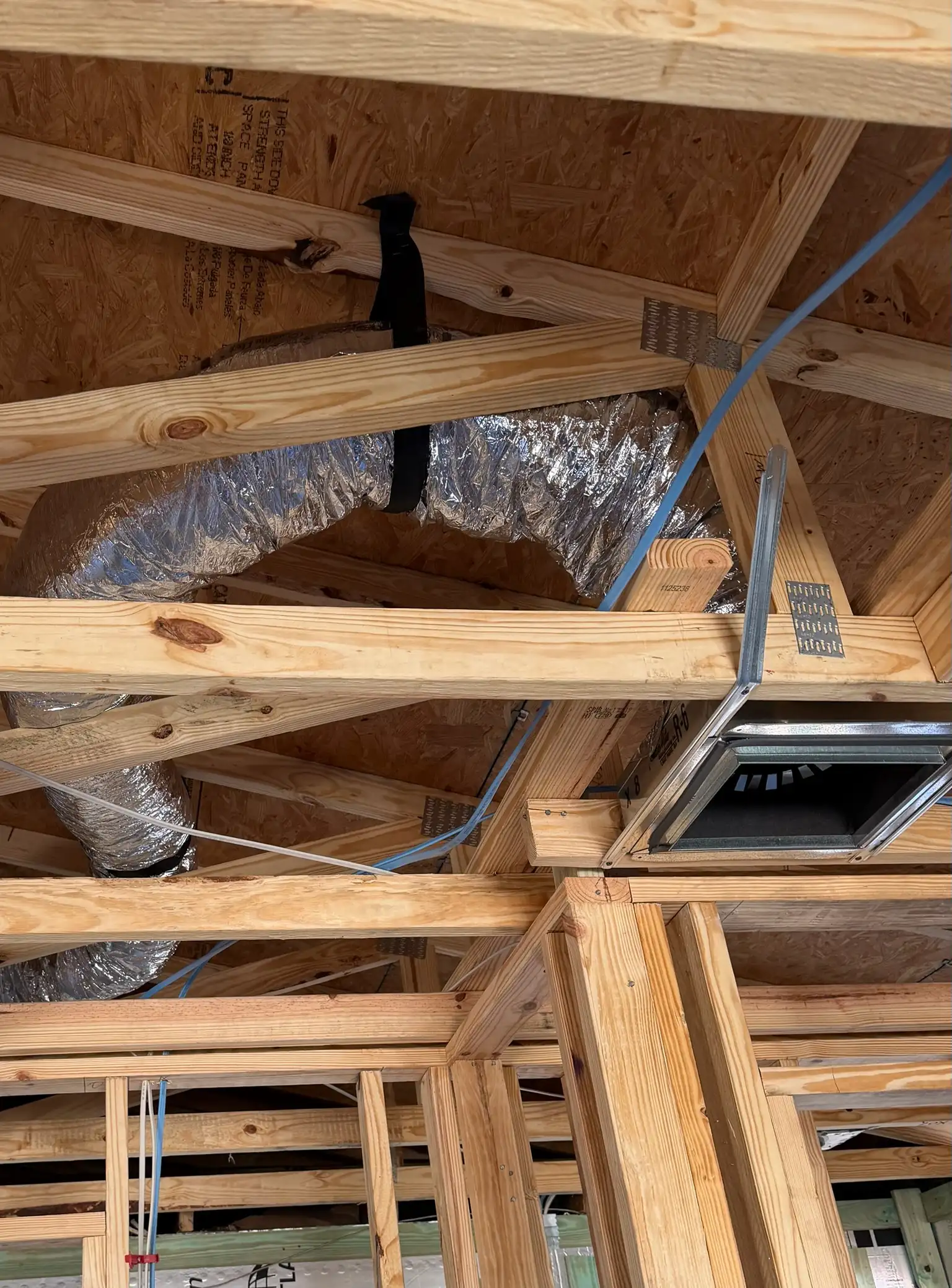 HVAC ductwork installation in attic during new construction for proper air distribution and system performance