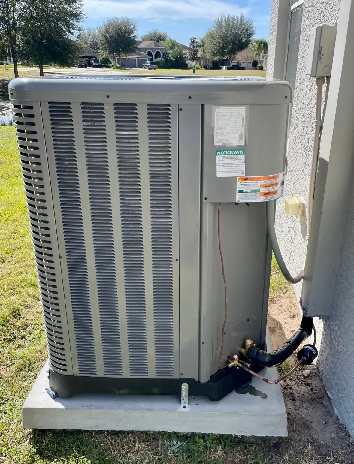 Residential outdoor HVAC unit installation in St. Petersburg, FL by Mandr Air Conditioning for air quality control.