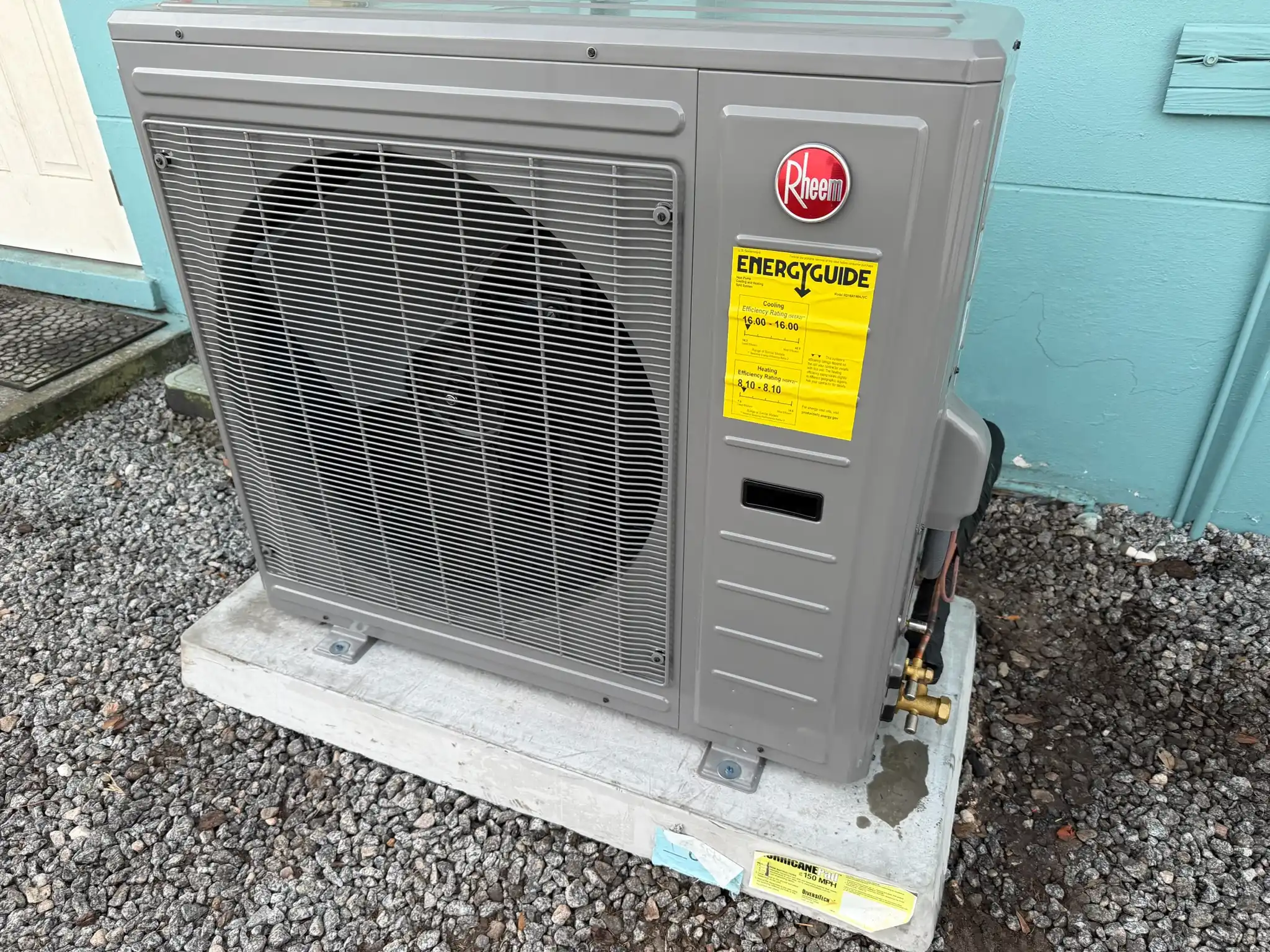 Newly installed Rheem HVAC unit with EnergyGuide label, providing efficient cooling and heating for a residential property in St. Petersburg.