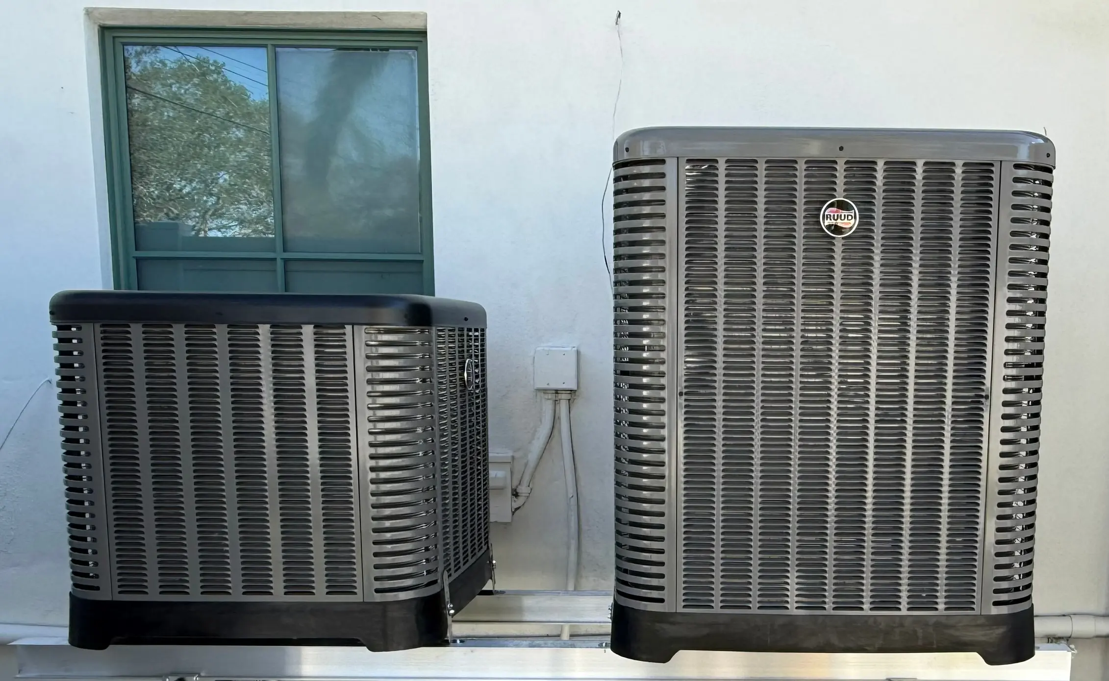 Ruud residential HVAC units installation with plumbing connections in St. Petersburg, FL."