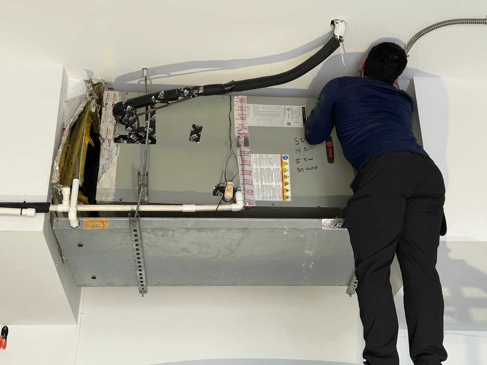 MandR HVAC Technician Fixing Wiring Issue
